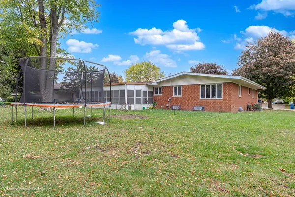 a view of a house with a backyard