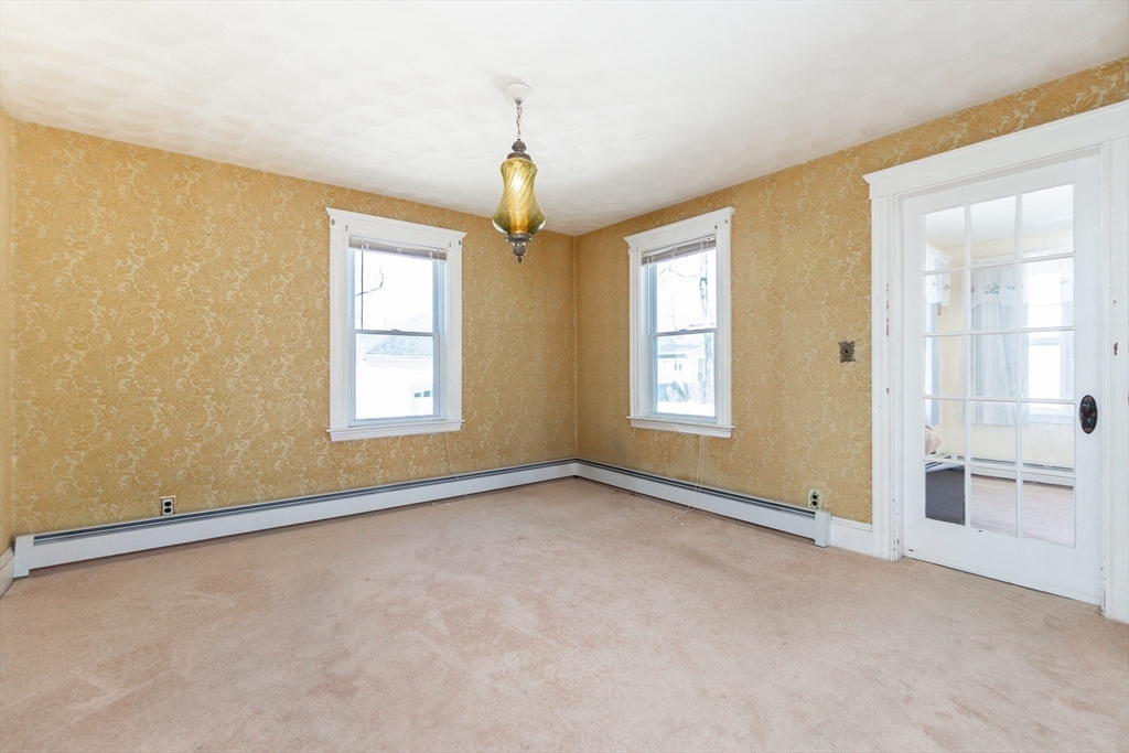 2 Sheldon Road Peabody, MA 01960 - Photo 13 of 42 an empty room with windows and chandelier