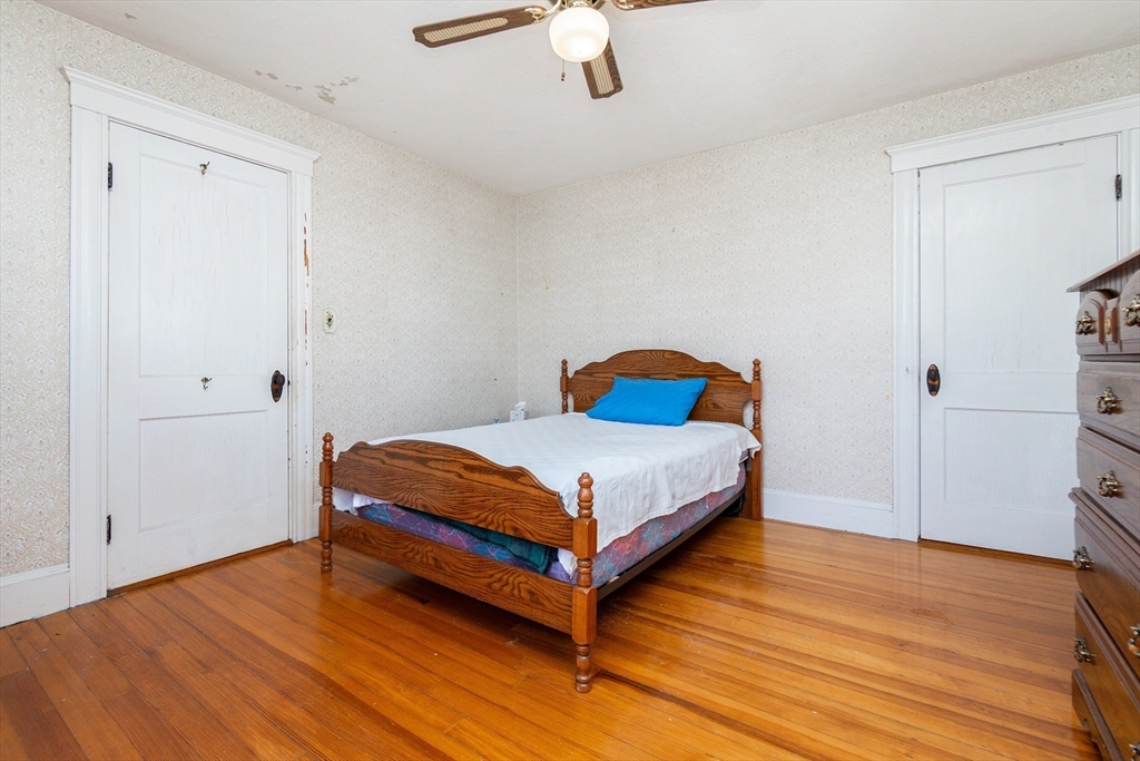 2 Sheldon Road Peabody, MA 01960 - Photo 23 of 42 a bedroom with a bed and wooden floor