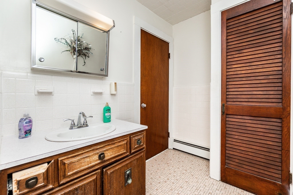 2 Sheldon Road Peabody, MA 01960 - Photo 25 of 42 a hallway with a sink and cabinets