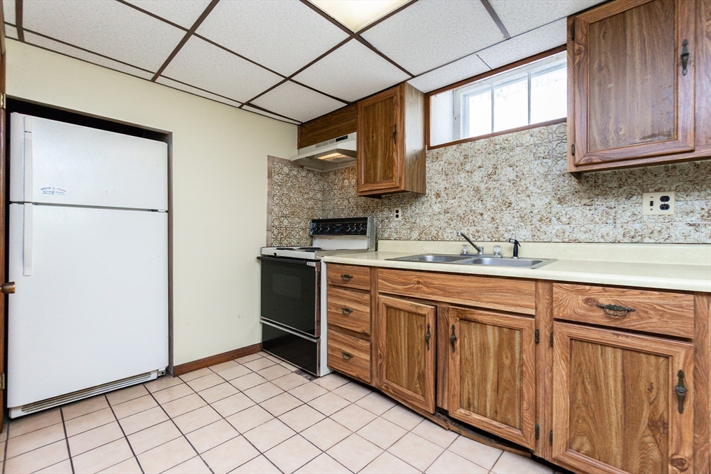 2 Sheldon Road Peabody, MA 01960 - Photo 30 of 42 a kitchen with stainless steel appliances wooden cabinets and a sink
