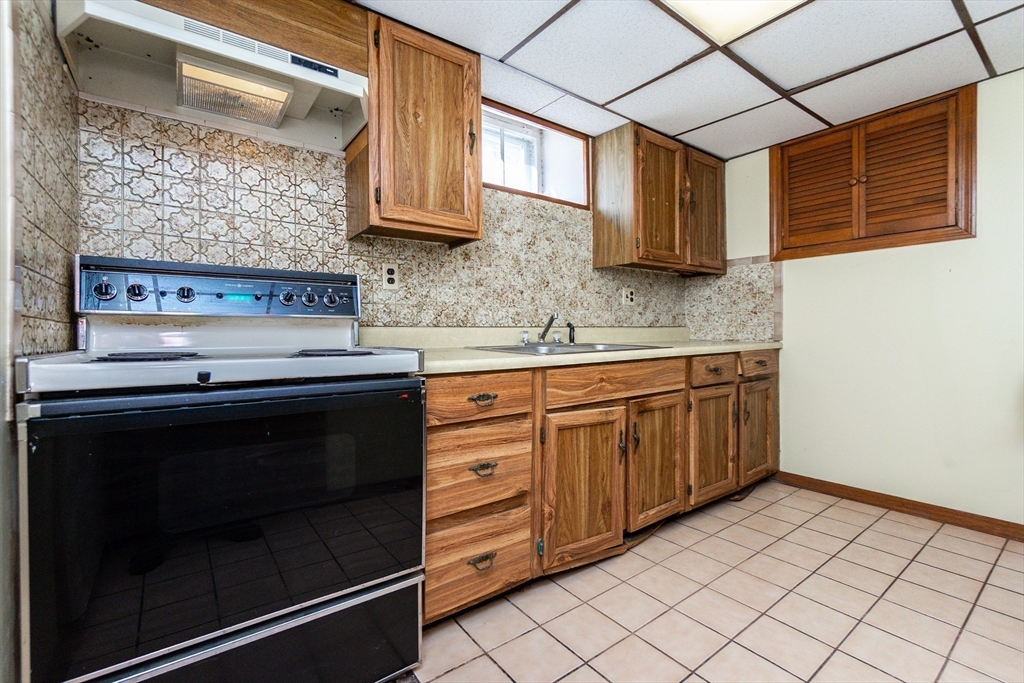 2 Sheldon Road Peabody, MA 01960 - Photo 31 of 42 a kitchen with stainless steel appliances granite countertop a stove a sink and a microwave