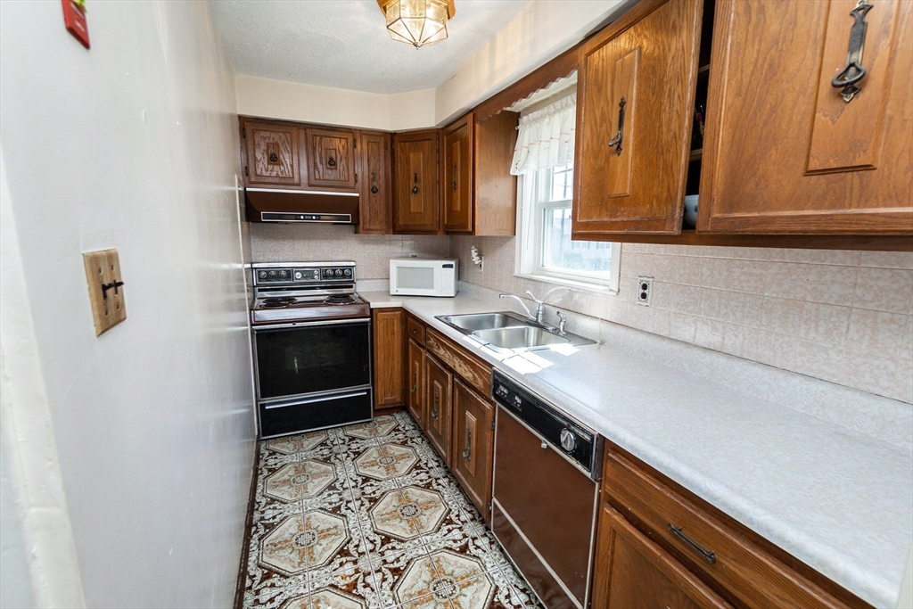 2 Sheldon Road Peabody, MA 01960 - Photo 6 of 42 a kitchen with stainless steel appliances a sink stove and cabinets