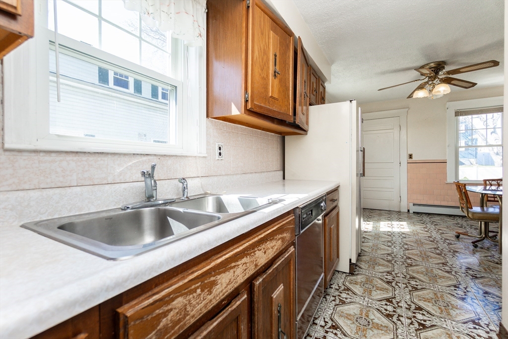 2 Sheldon Road Peabody, MA 01960 - Photo 7 of 42 a kitchen with stainless steel appliances granite countertop a sink stove and cabinets