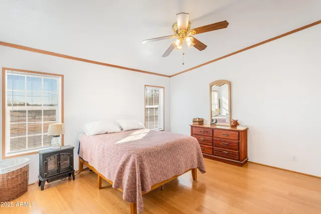 a bedroom with a bed and a large mirror