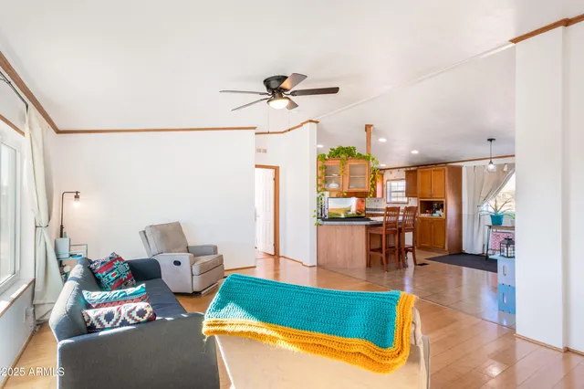a living room with patio furniture and a large window