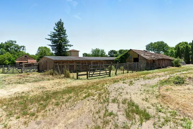 a backyard of a house with table and chairs