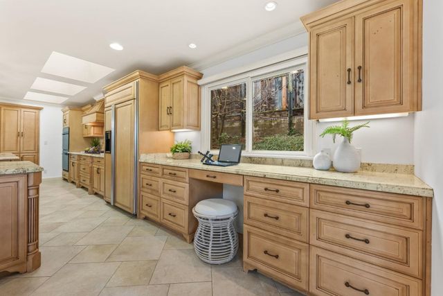 a kitchen with a refrigerator oven stove and a sink