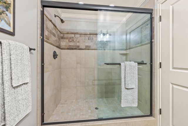 a bathroom with a glass shower door