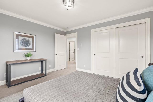 a bedroom with a bed and a painting on the wall