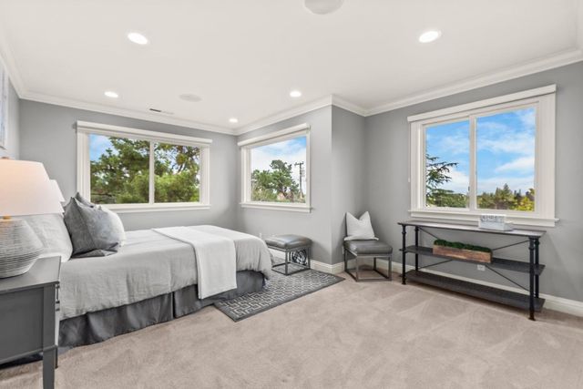 a bedroom with two beds and a large window