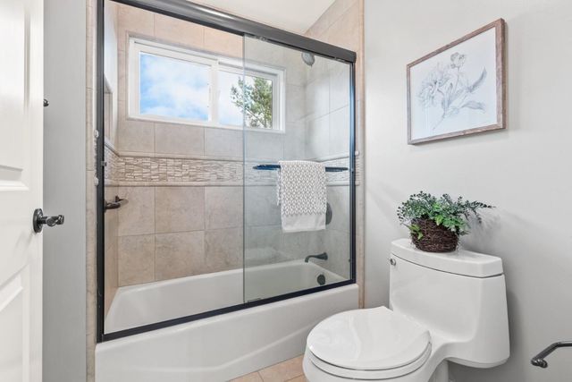 a white toilet sitting next to a bathroom