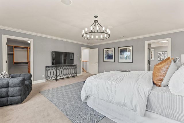 a bedroom with a large bed and a window