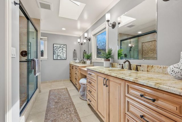 a spacious bathroom with a granite countertop sink and a mirror