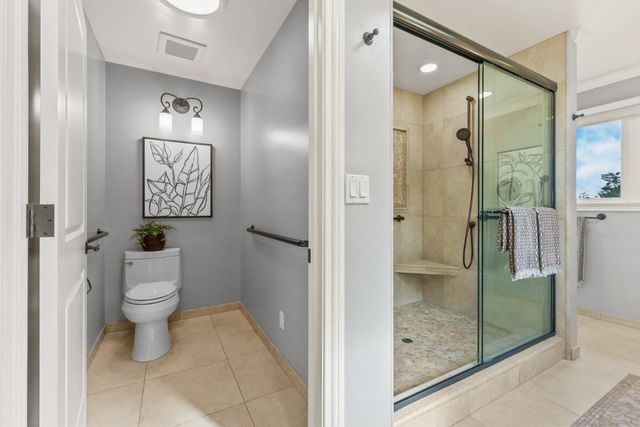 a bathroom with a shower a toilet and a sink