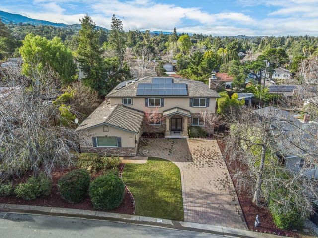 an aerial view of a house with a yard