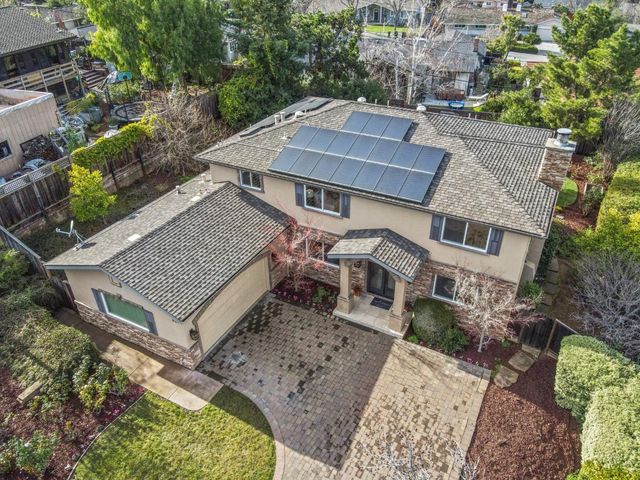 an aerial view of a house with a yard and balcony