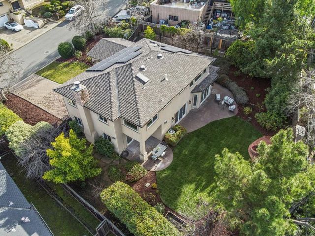 an aerial view of a house with a yard