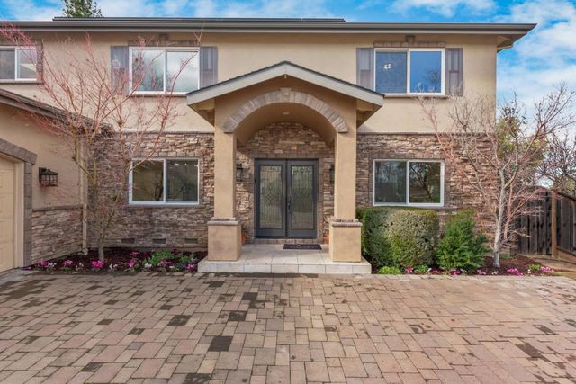 a front view of a house with garden