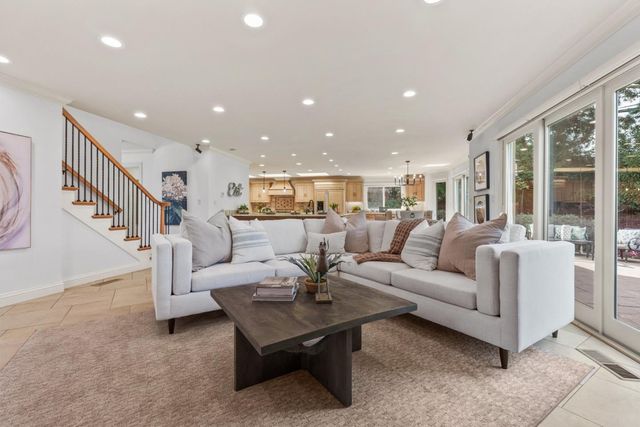 a living room with furniture ceiling fan and a rug