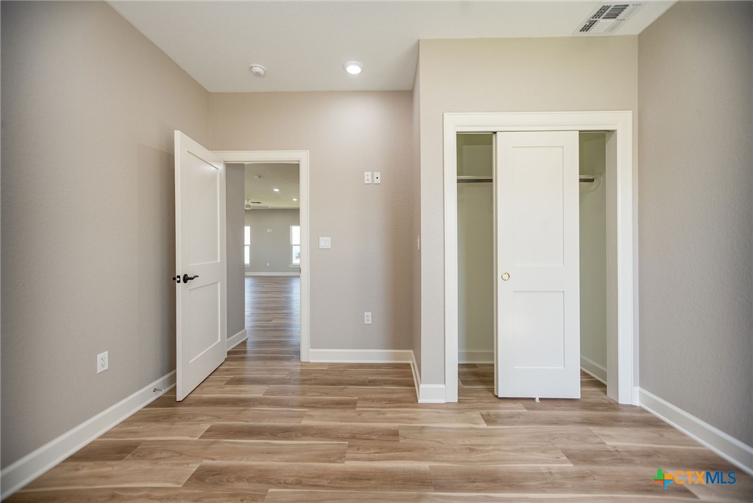 116 Whooping Crane Street Port O'Connor, TX 77982 - Photo 11 of 38 a view of a hallway with wooden floor and closet area