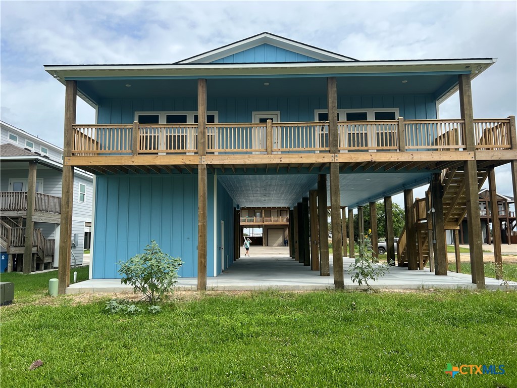 116 Whooping Crane Street Port O'Connor, TX 77982 - Photo 37 of 38 a front view of a house with a yard