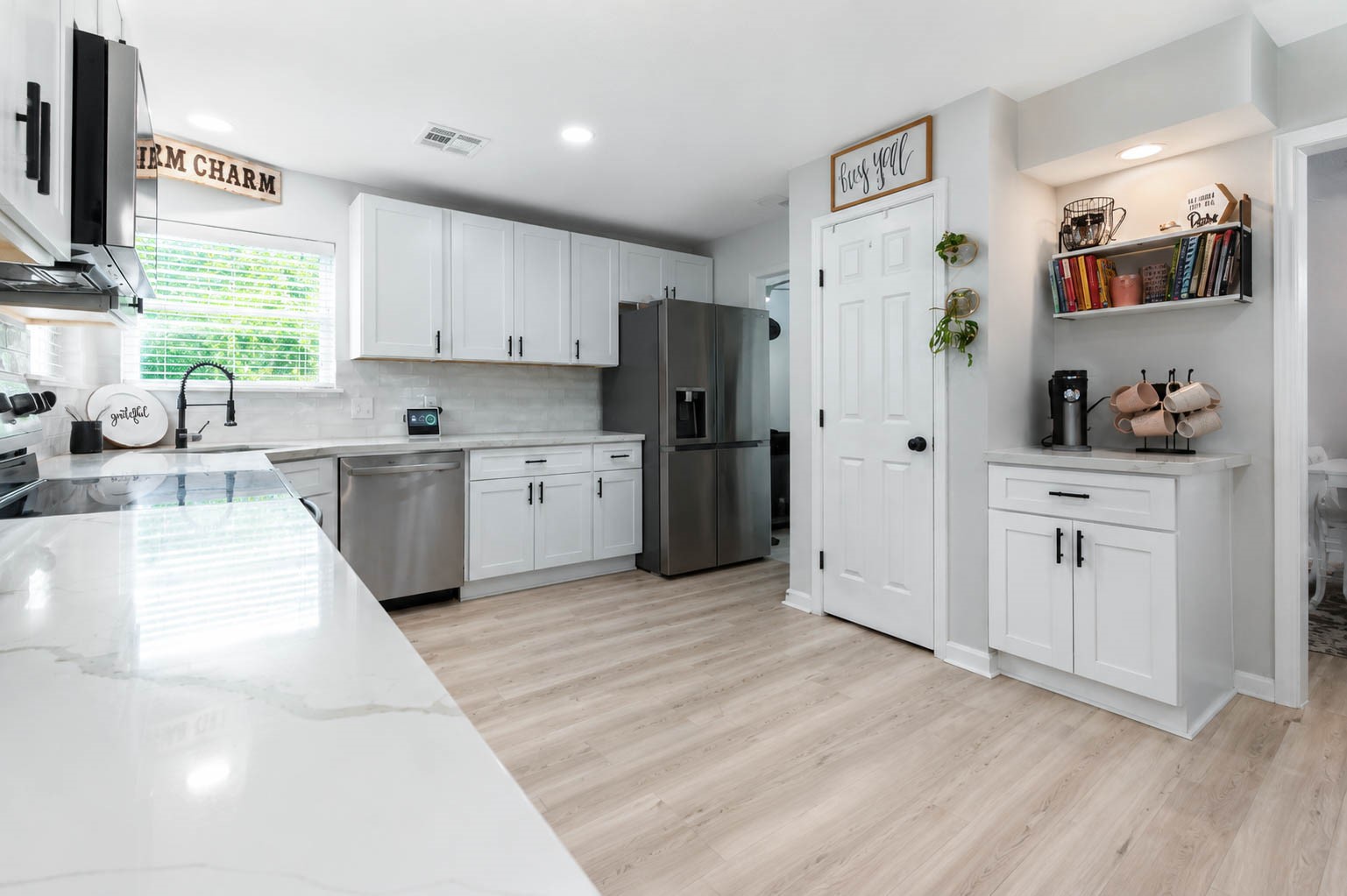 630 South Fry Road Katy, TX 77450 - Photo 16 of 48 Bright and modern kitchen featuring sleek white cabinetry, stainless steel appliances, and a stylish tile backsplash, perfect for culinary creativity.