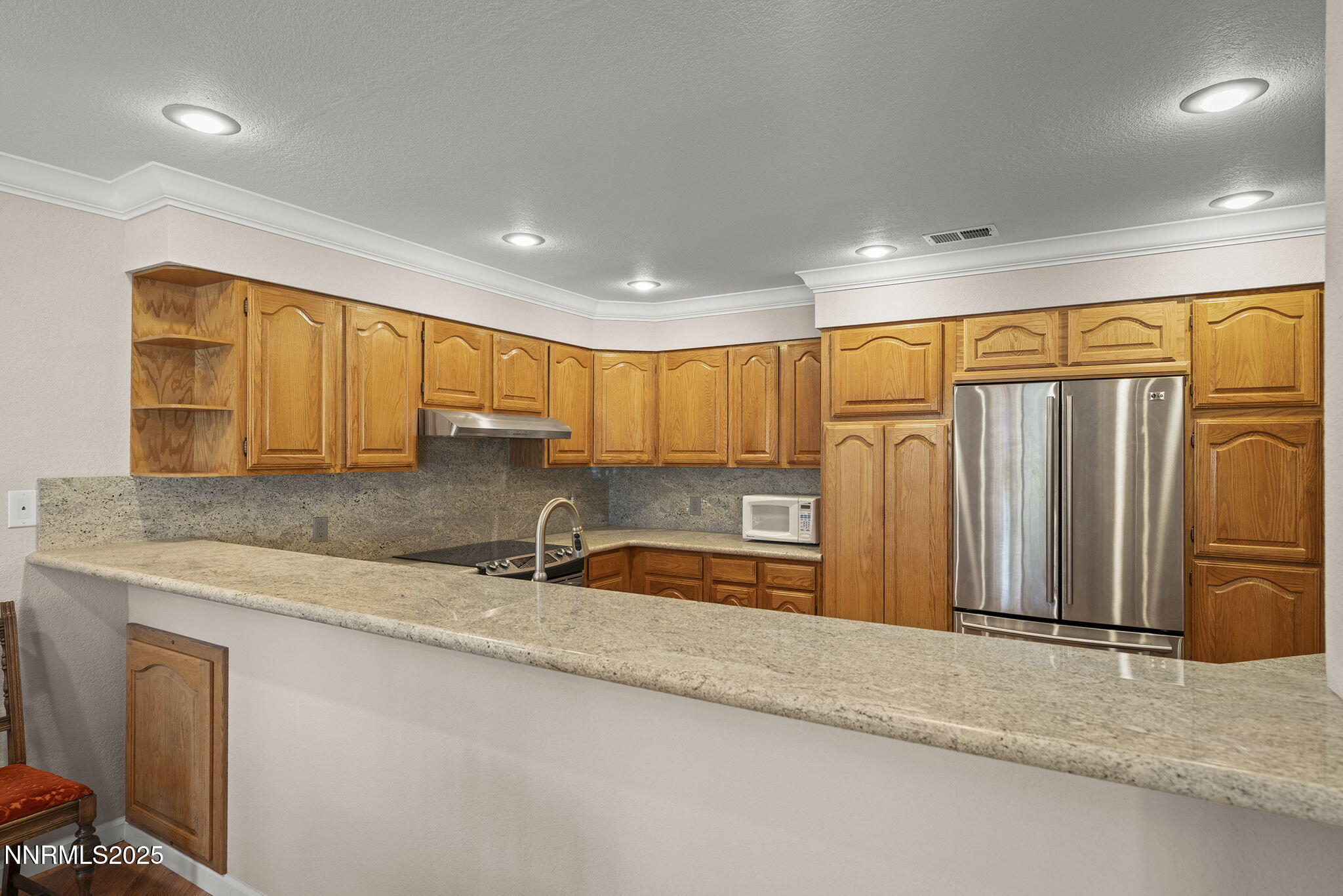 3601 Skyline Boulevard, Unit 34 Reno, NV 89509 - Photo 9 of 26 a kitchen with stainless steel appliances granite countertop a sink a refrigerator and a granite counter top