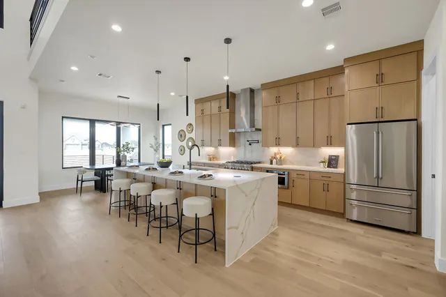 a living room with fireplace furniture and a large window