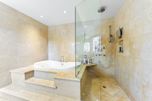 a bathroom with a bathtub shower sink and toilet