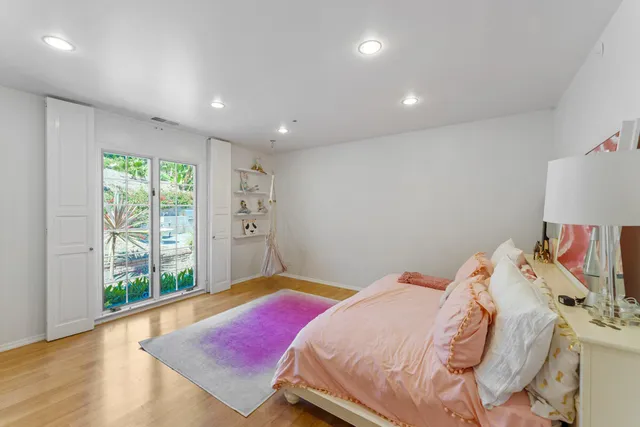 a bedroom with a bed and a large window