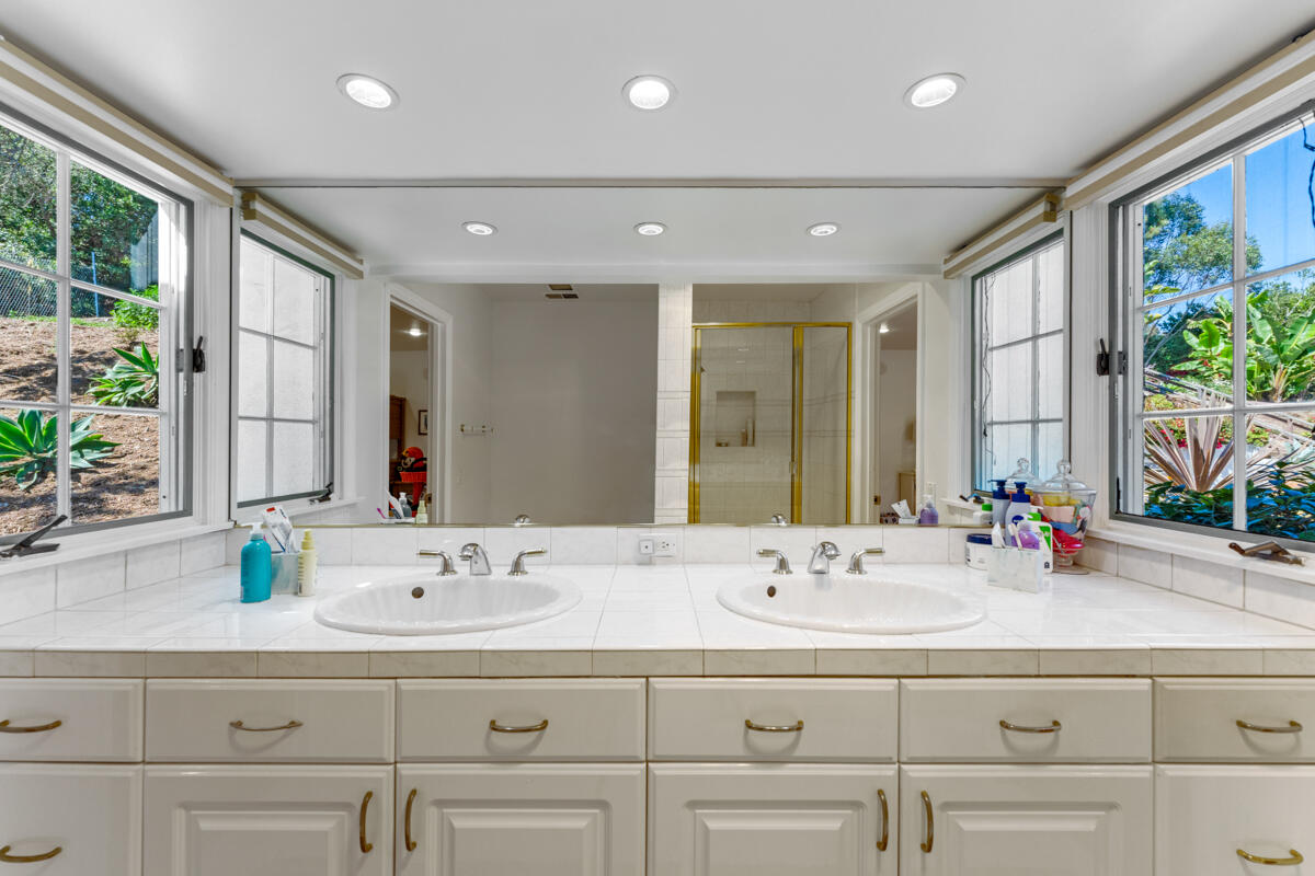 1020 Alston Road Montecito, CA 93108 - Photo 27 of 35 a bathroom with double vanity sinks and a mirror