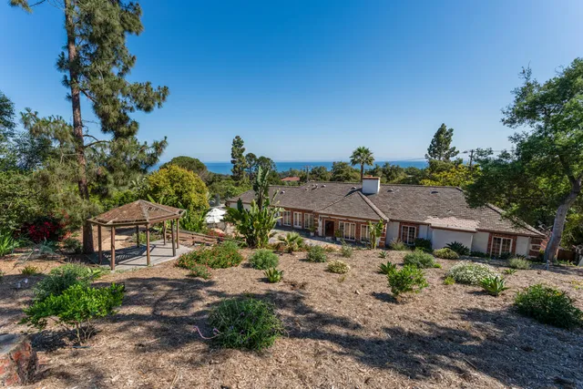 a aerial view of a house with a yard and sitting area