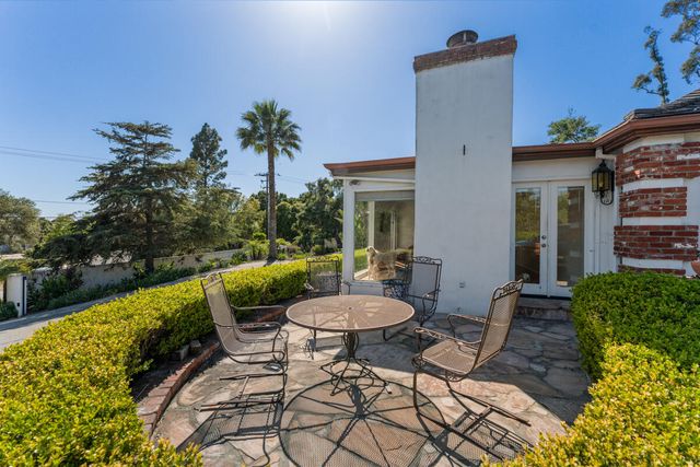 a backyard of a house with table and chairs