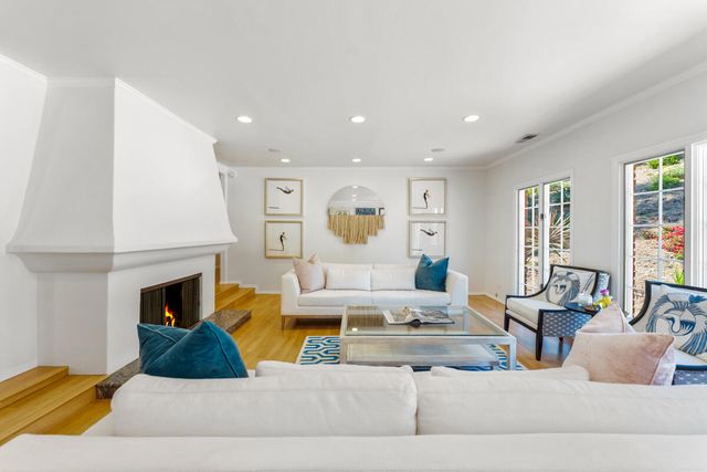 a living room with furniture fireplace and window