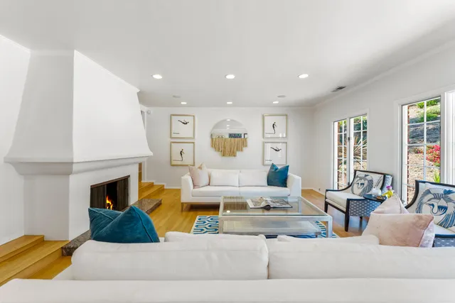 a living room with furniture fireplace and window
