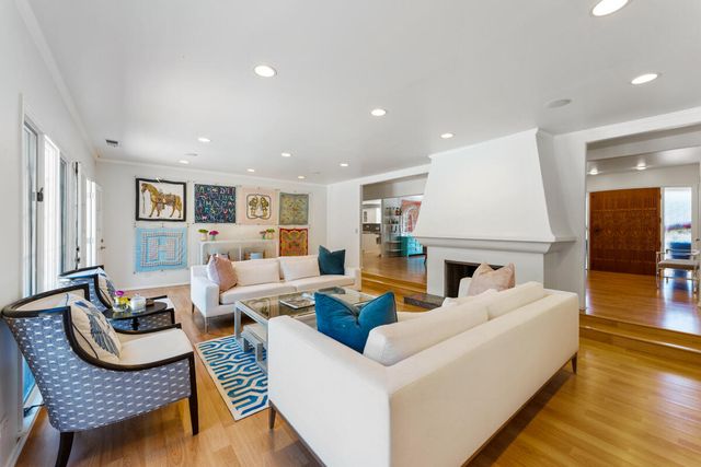 a living room with furniture or kitchen and a wooden floor