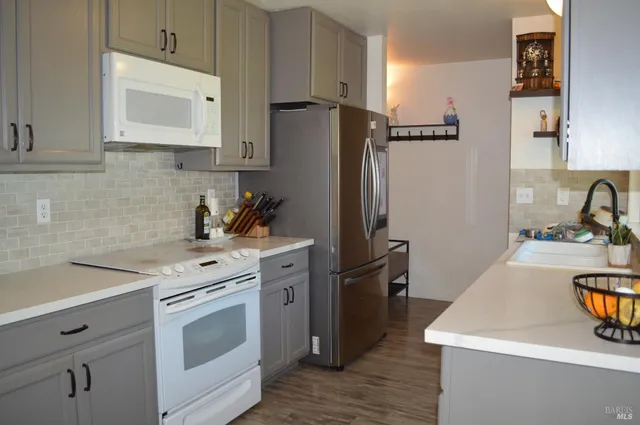 a kitchen with a sink stove and refrigerator