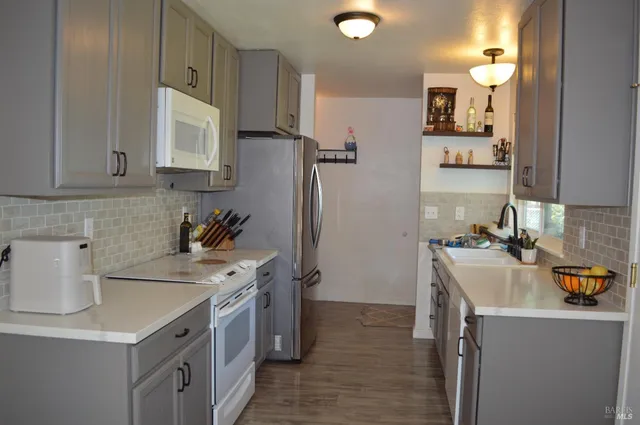 a kitchen with a sink stove and refrigerator