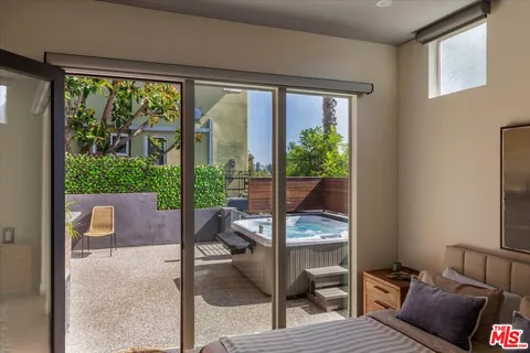 a living room with furniture and a floor to ceiling window
