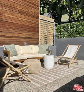 a view of a patio with table and chairs and wooden floor