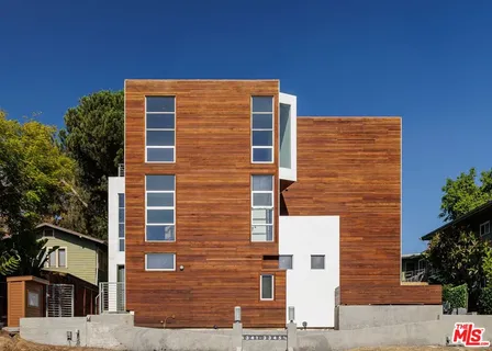 a front view of a building with plants