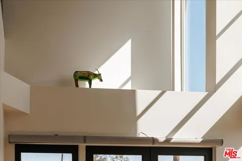a view of living room with a window and a bed