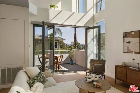 a work room with furniture and a floor to ceiling window