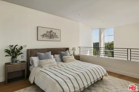 a bedroom with a large bed and a large window
