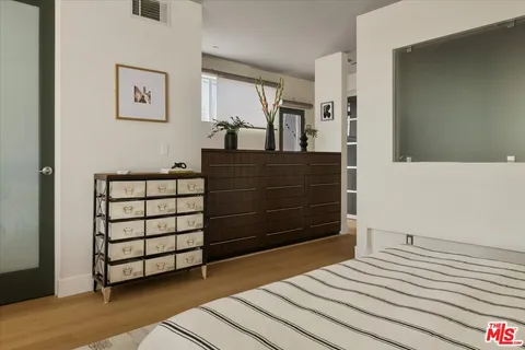 a bedroom with a bed and a dresser