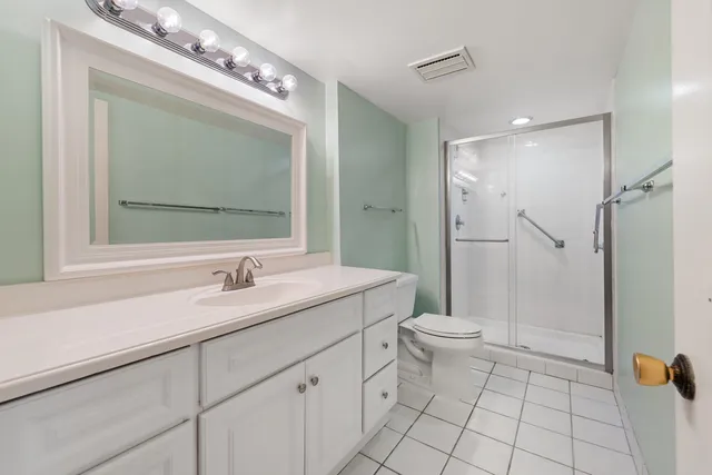 a spacious bathroom with a granite countertop tub sink and mirror