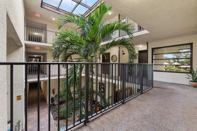 an aerial view of a house with a garden and lake view
