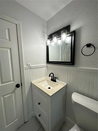 a bathroom with a double vanity sink and mirror