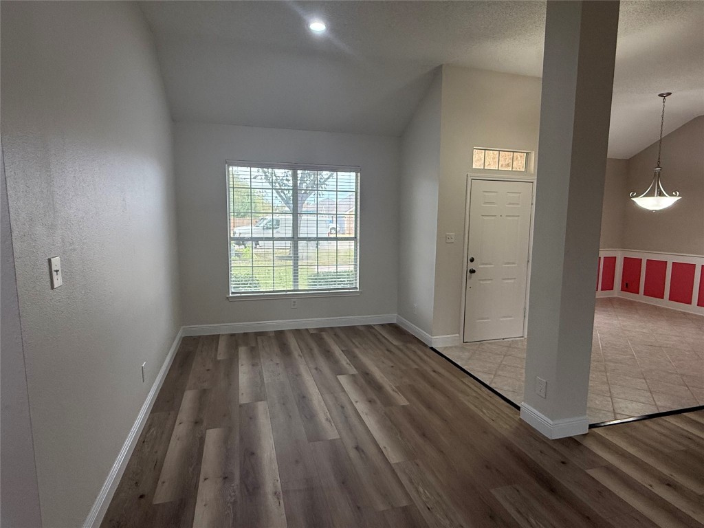11711 Rydalwater Lane Austin, TX 78754 - Photo 2 of 20 Entryway with vaulted ceiling, light wood-style flooring, and a textured ceiling